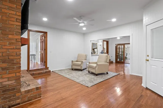 a living room with furniture and wooden floor