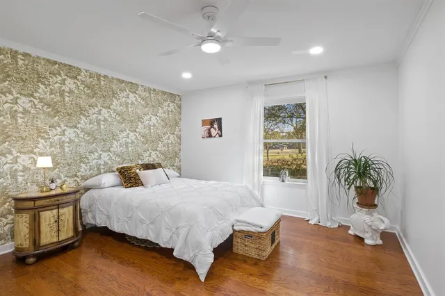 a bedroom with a bed and a potted plant