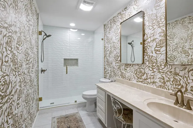 a bathroom with a sink toilet and shower