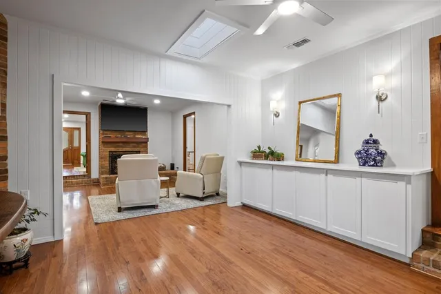 a view of living room with furniture and wooden floor
