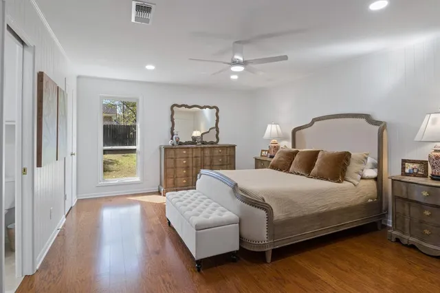 a bedroom with a large bed and a chandelier