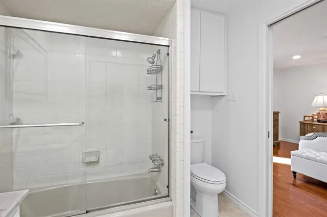 a bathroom with a shower a toilet and a sink