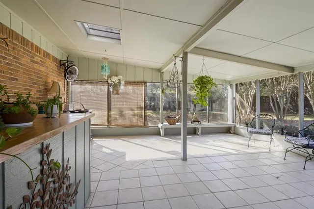 a room with lots of furniture and a glass door