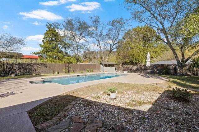 a view of a swimming pool with a patio