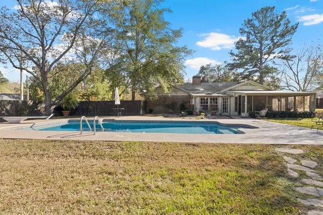 a view of a yard with plants and trees