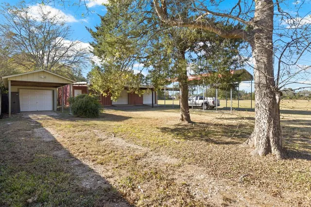 a view of a house with a backyard patio and swimming pool
