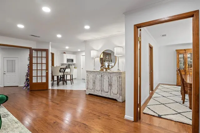 a view of a kitchen with furniture and wooden floor