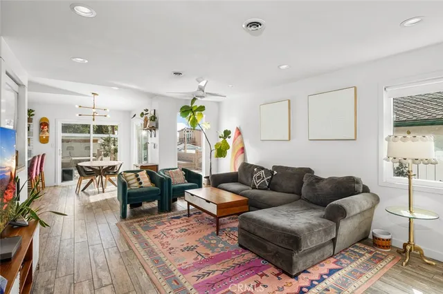 a living room with furniture and wooden floor