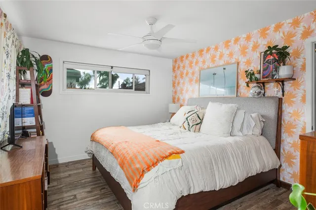 a bedroom with a bed and a painting on the wall