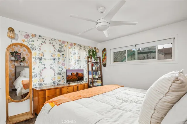 a bedroom with bed and wooden floor
