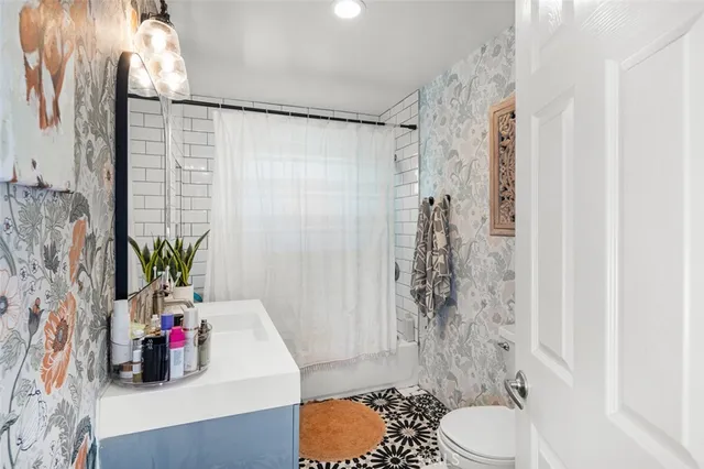 a bathroom with a sink toilet and shower