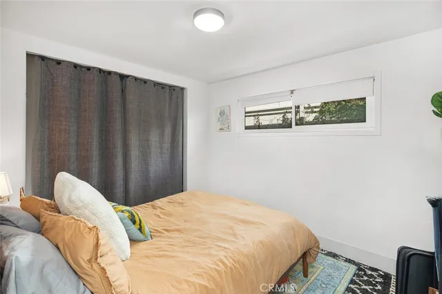 a bedroom with a bed and a wall painting