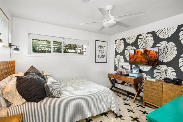 a bedroom with a bed and ceiling fan