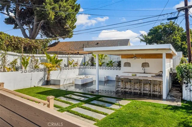 a view of a patio with table and chairs potted plants and palm trees