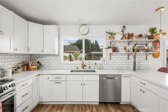 a kitchen with cabinets appliances and a sink