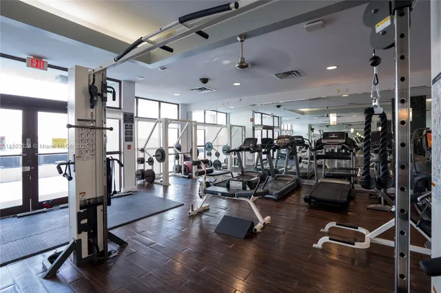 a view of a room with lots of furniture and wooden floor