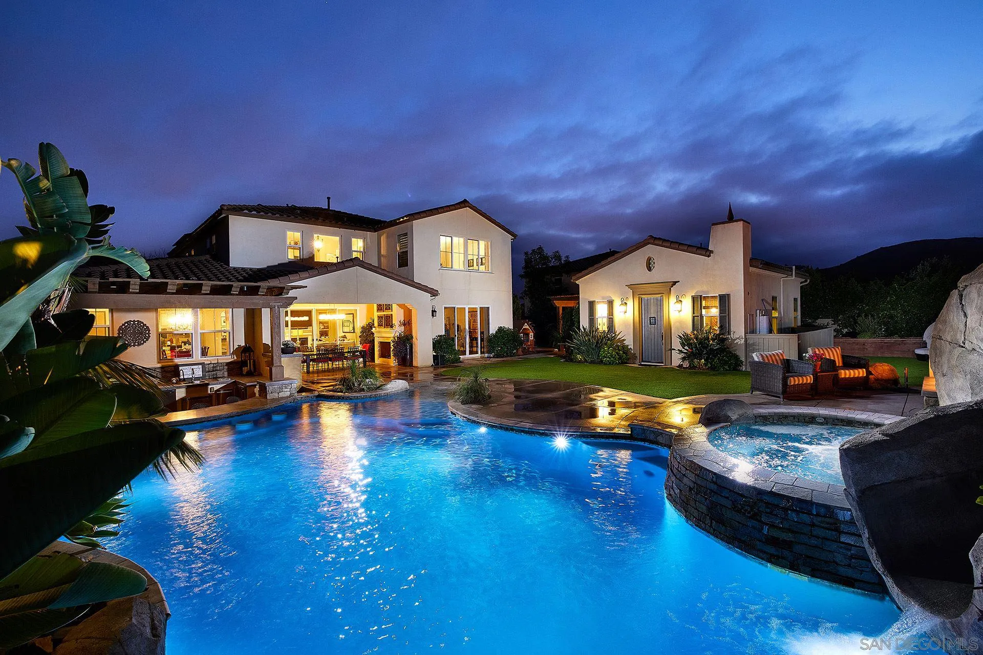 a view of a house with swimming pool and sitting area