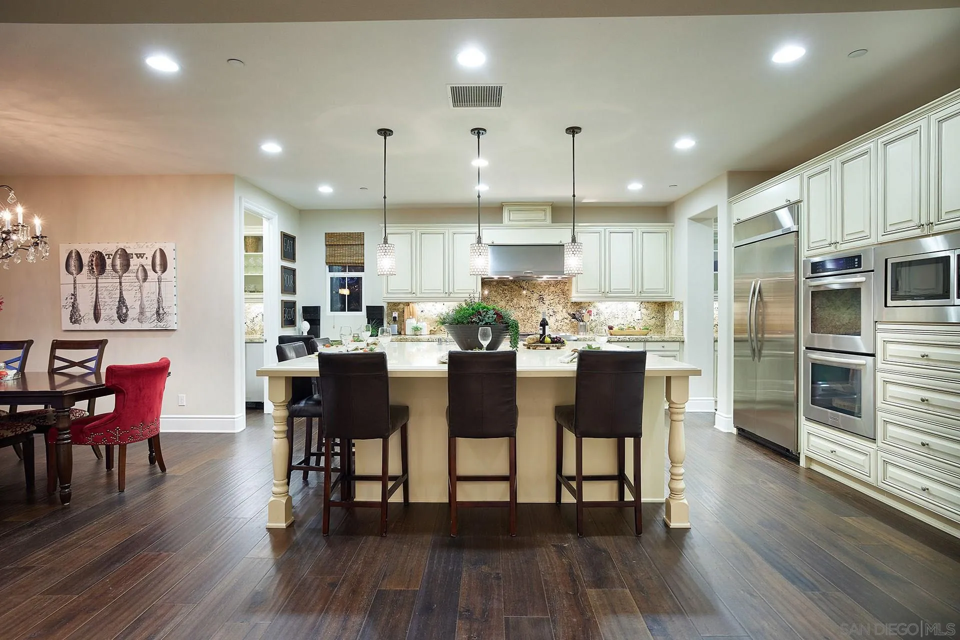 17778 Ralphs Ranch Road San Diego, CA 92127 - Photo 14 of 48 a kitchen with stainless steel appliances kitchen island granite countertop a table chairs and a refrigerator