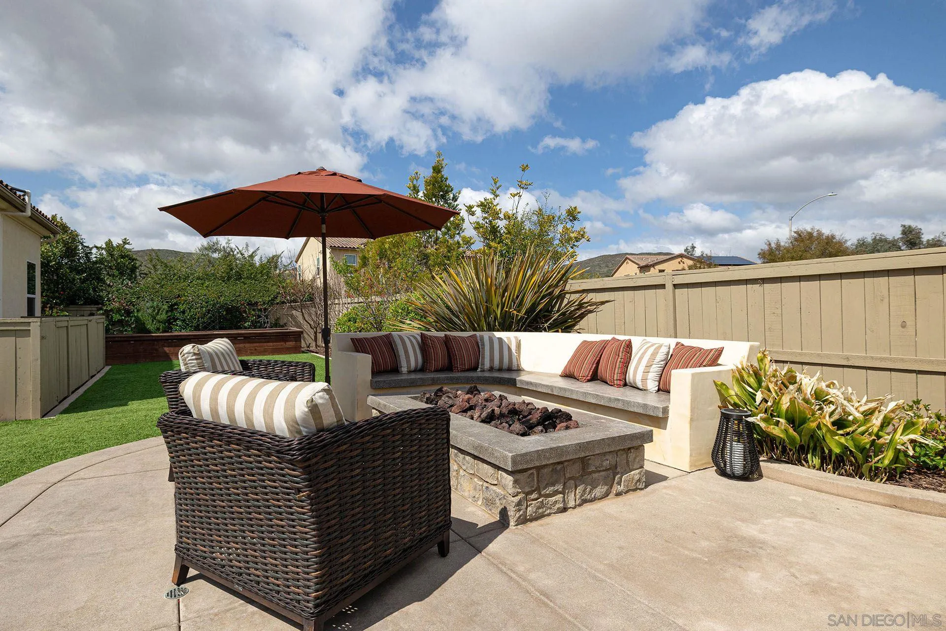 17778 Ralphs Ranch Road San Diego, CA 92127 - Photo 45 of 48 a view of a patio with couches table and chairs under an umbrella