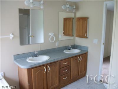 410 F Road LaBelle, FL 33935 - Photo 3 of 8 a bathroom with a sink double vanity and a mirror