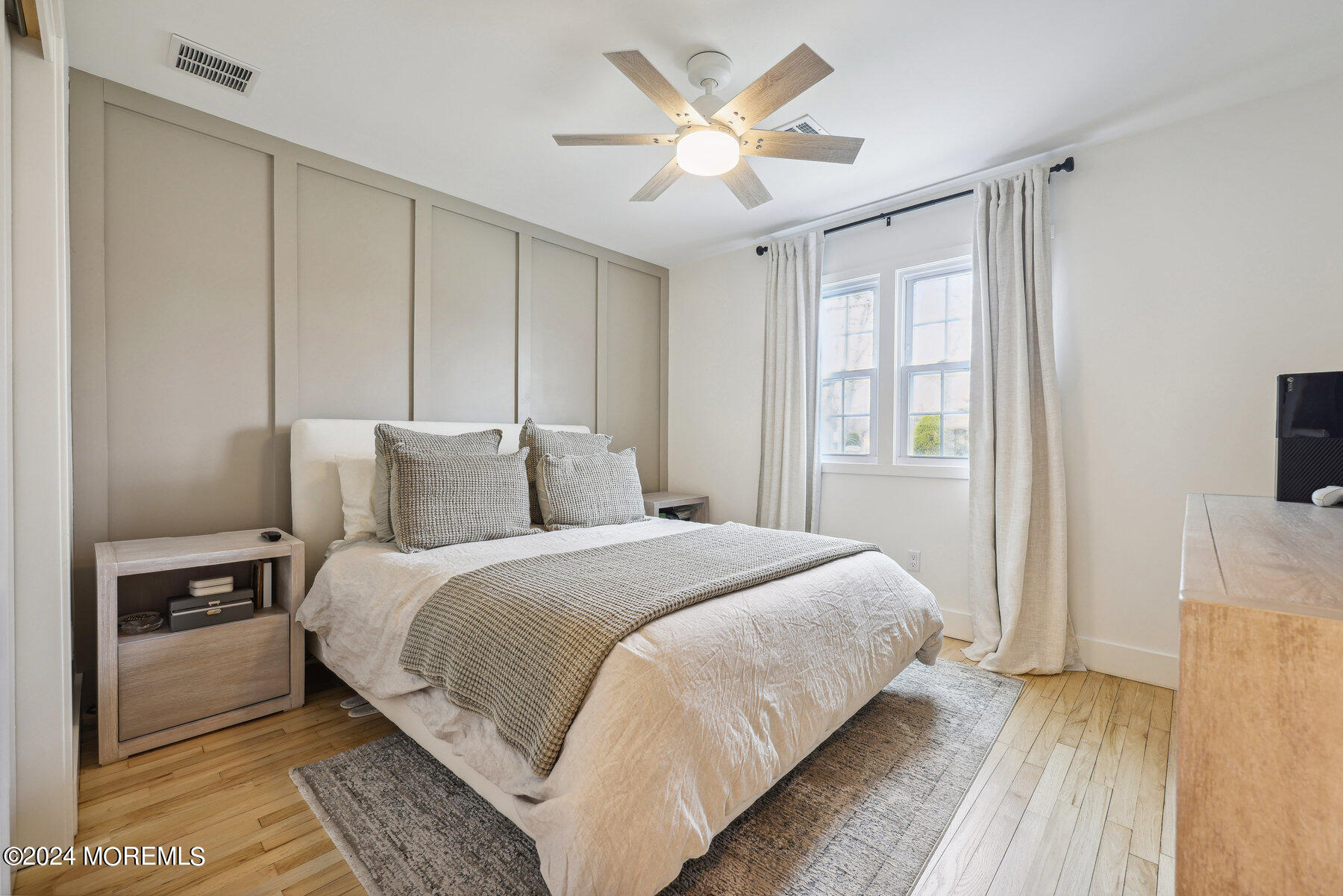 2572 Summit Road Manasquan, NJ 08736 - Photo 21 of 28 a bedroom with a large bed and a chandelier