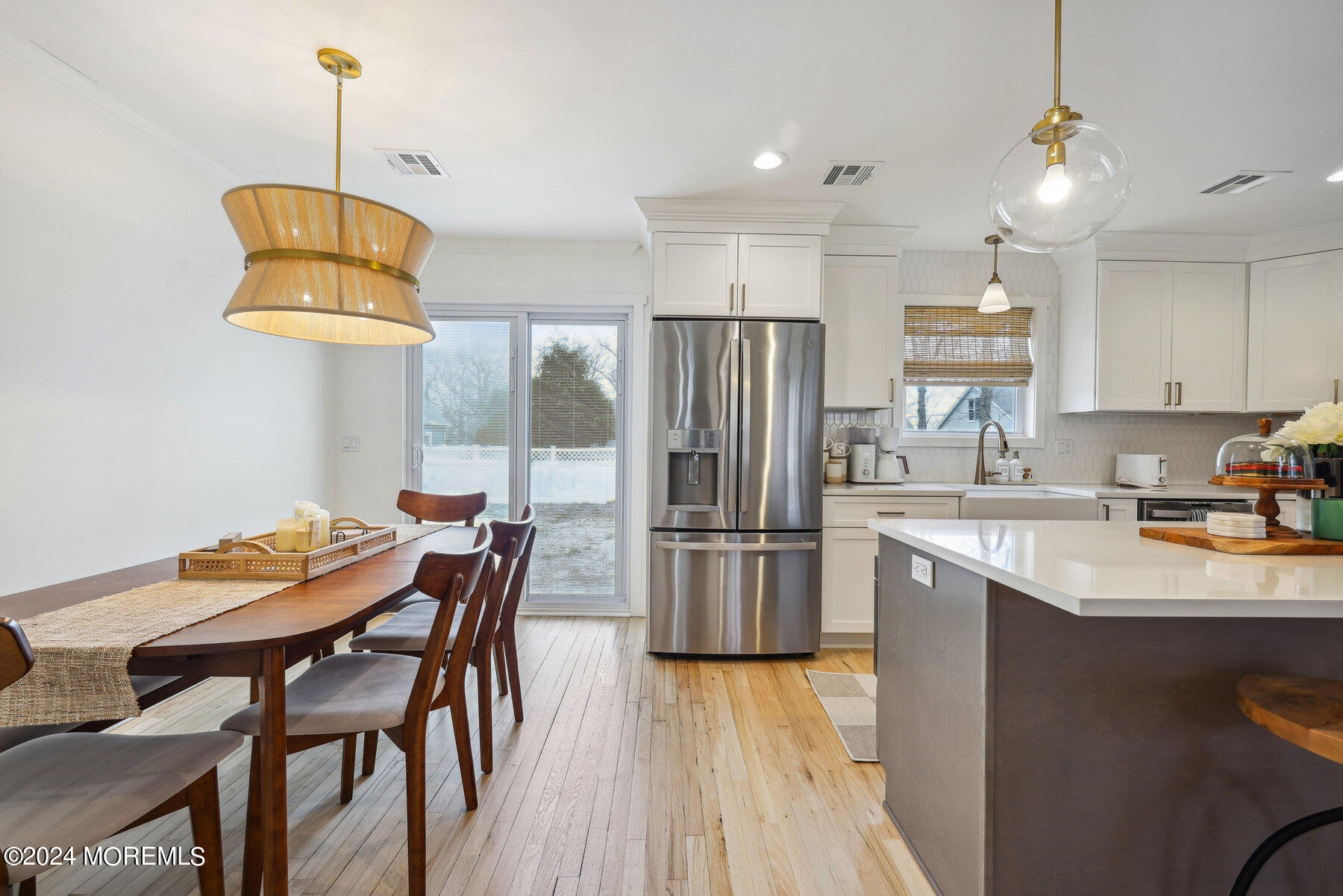 2572 Summit Road Manasquan, NJ 08736 - Photo 7 of 28 a kitchen with stainless steel appliances granite countertop a refrigerator a sink dishwasher a stove and a dining table with wooden floor