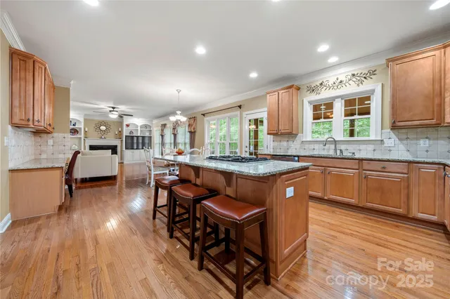 a large kitchen with lots of counter space and a wooden floors