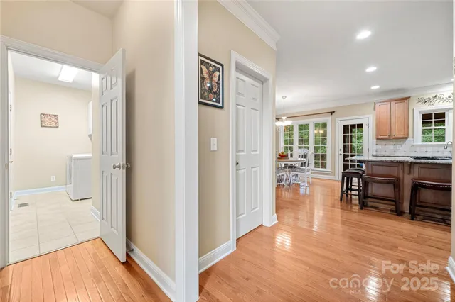 a view of a dining room with furniture a chandelier and wooden floor