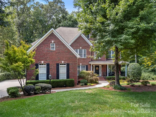 a view of house with outdoor seating space and garden