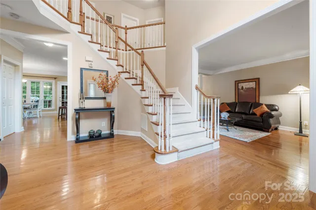 a view of entryway and hall with wooden floor