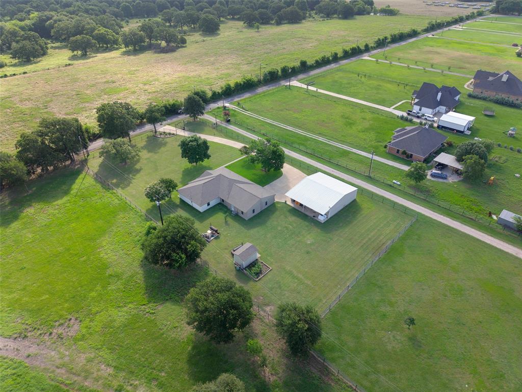 380 Farr Altom Road Seagoville, TX 75159 - Photo 28 of 30 Expansive acreage featuring a single-story residence with a gabled roof, an auxiliary metal building, and a separate detached shed