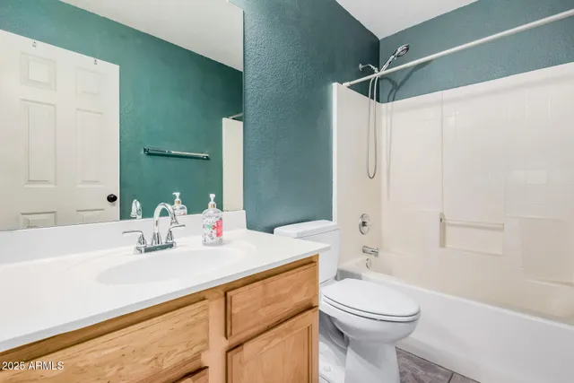 a bathroom with a sink toilet vanity and shower