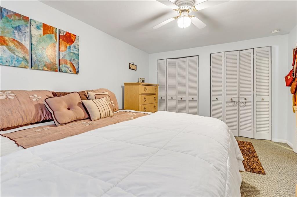 203 Beech Road Pittsburgh, PA 15239 - Photo 12 of 21 a bedroom with a large bed and a chandelier
