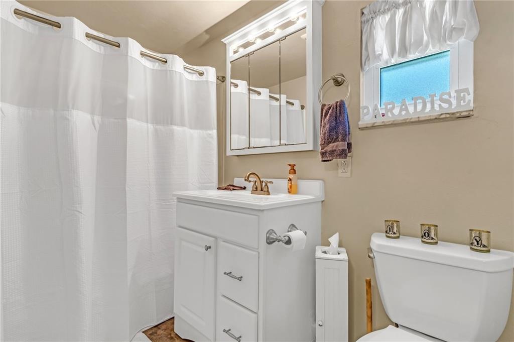 203 Beech Road Pittsburgh, PA 15239 - Photo 15 of 21 a bathroom with a sink and mirror with toilet