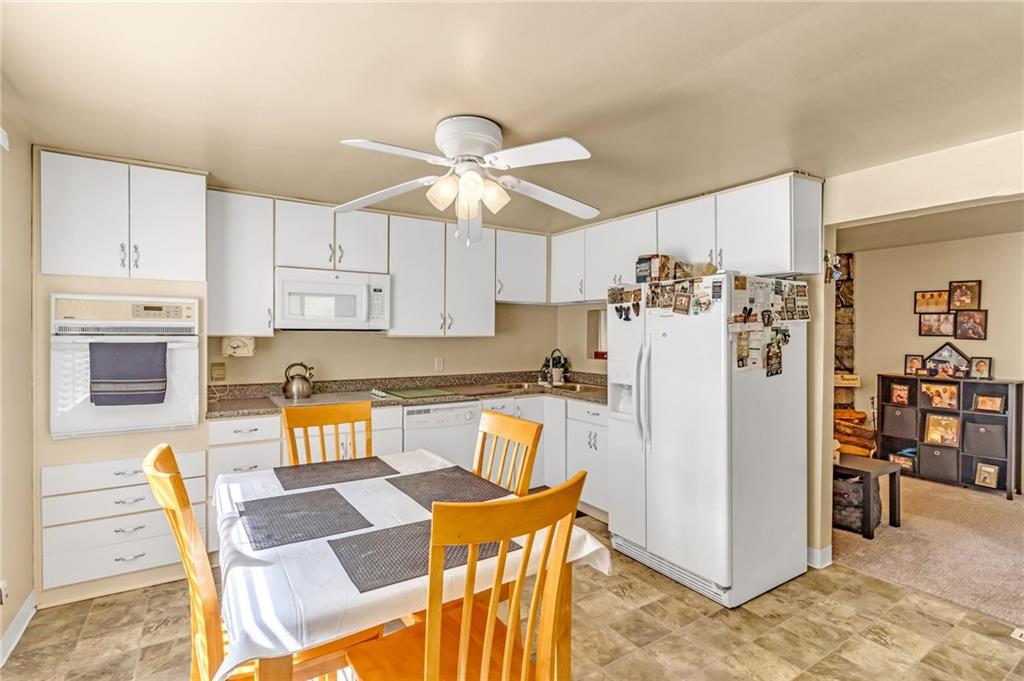 203 Beech Road Pittsburgh, PA 15239 - Photo 5 of 21 a kitchen with stainless steel appliances kitchen island granite countertop a refrigerator and microwave