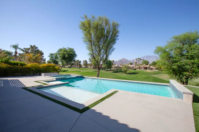 a view of swimming pool with yard and outdoor seating