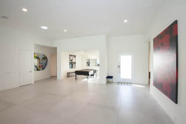 an empty room with furniture and a window
