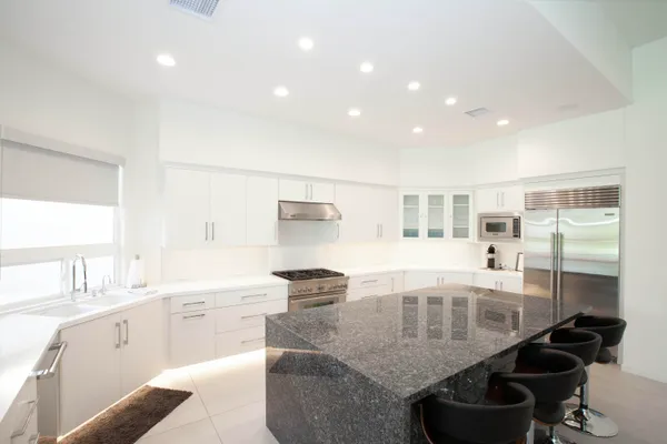 a kitchen with a table chairs stove and cabinets