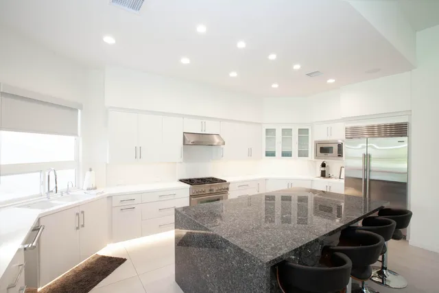 a kitchen with a table chairs stove and cabinets