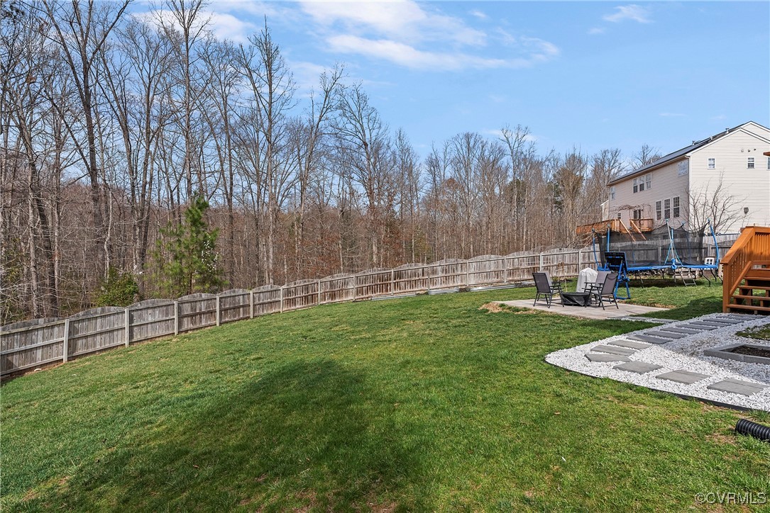 2112 Tomahawk Ridge Place Midlothian, VA 23112 - Photo 44 of 50 View of yard with a trampoline, a fenced backyard,