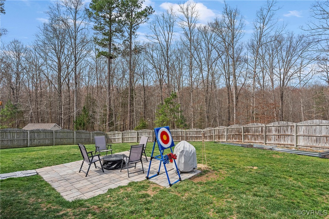 2112 Tomahawk Ridge Place Midlothian, VA 23112 - Photo 46 of 50 View of yard featuring a fenced backyard, a fire p