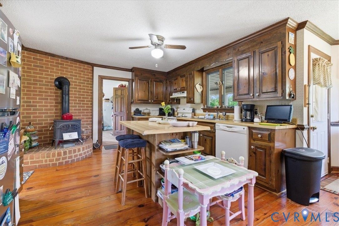 15414 Sunnybrook Road Petersburg, VA 23805 - Photo 11 of 29 a open kitchen with stainless steel appliances granite countertop a stove refrigerator and a dining table with wooden floor