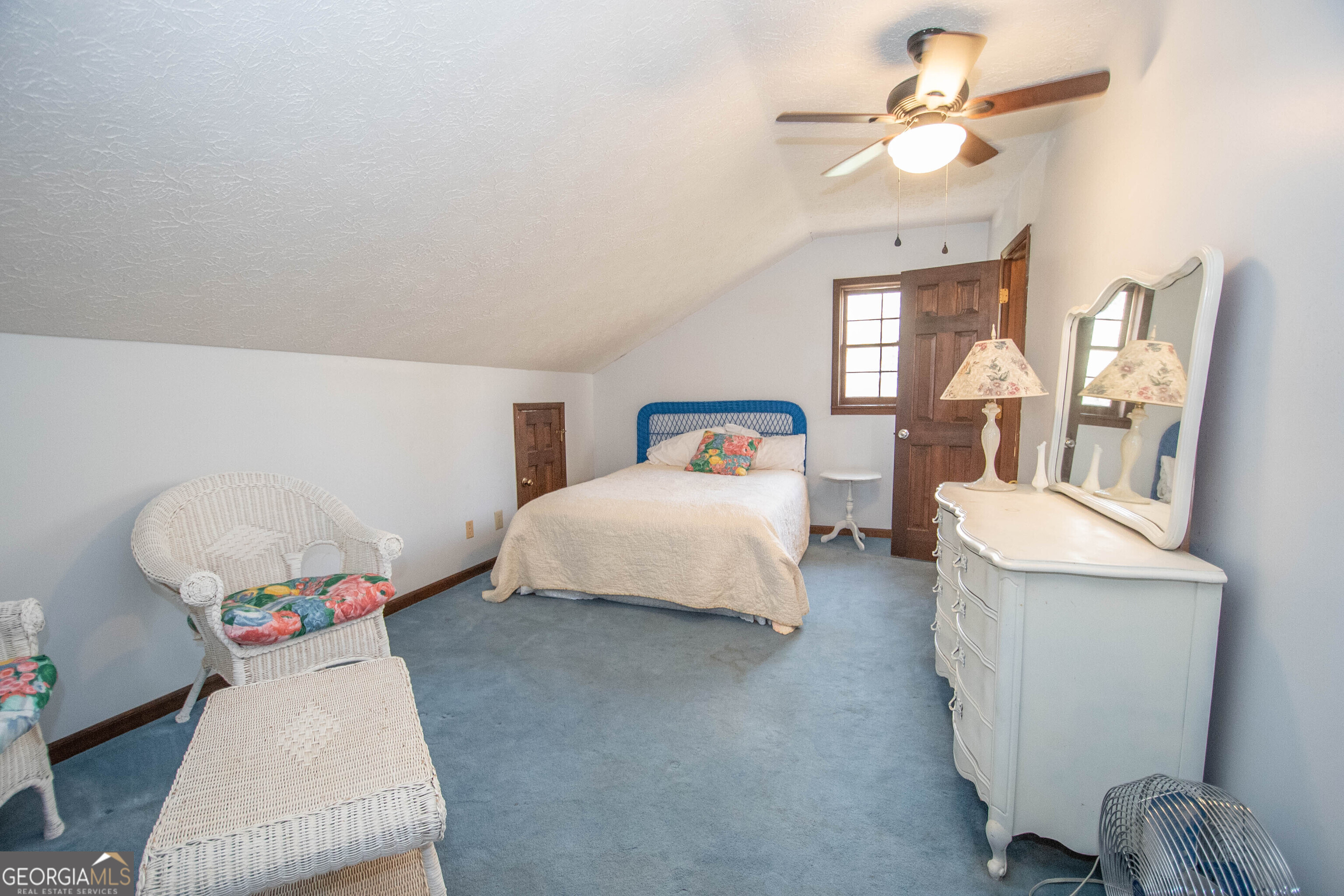 151 Evans Road Milner, GA 30257 - Photo 19 of 60 a bedroom with a bed and chandelier