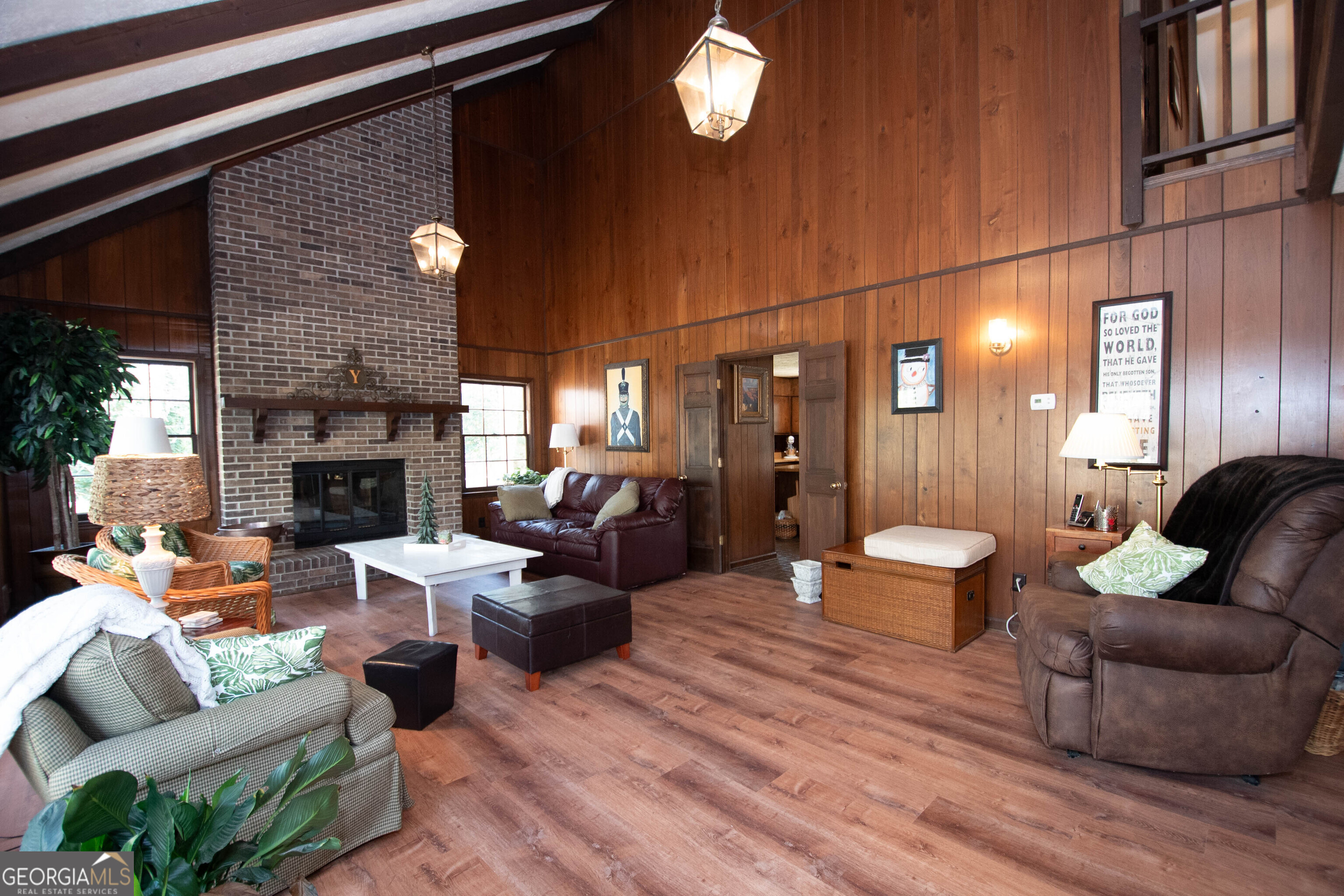 151 Evans Road Milner, GA 30257 - Photo 37 of 60 a living room with furniture a fireplace and a chandelier
