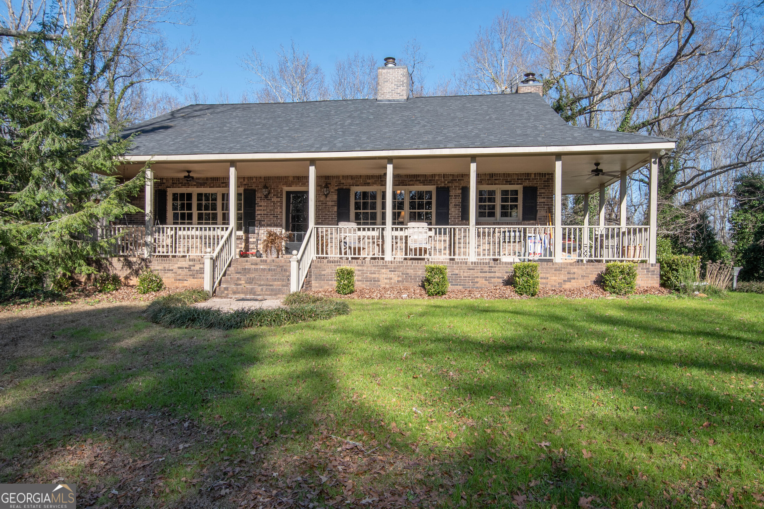151 Evans Road Milner, GA 30257 - Photo 38 of 60 a front view of a house with a yard garden and outdoor seating
