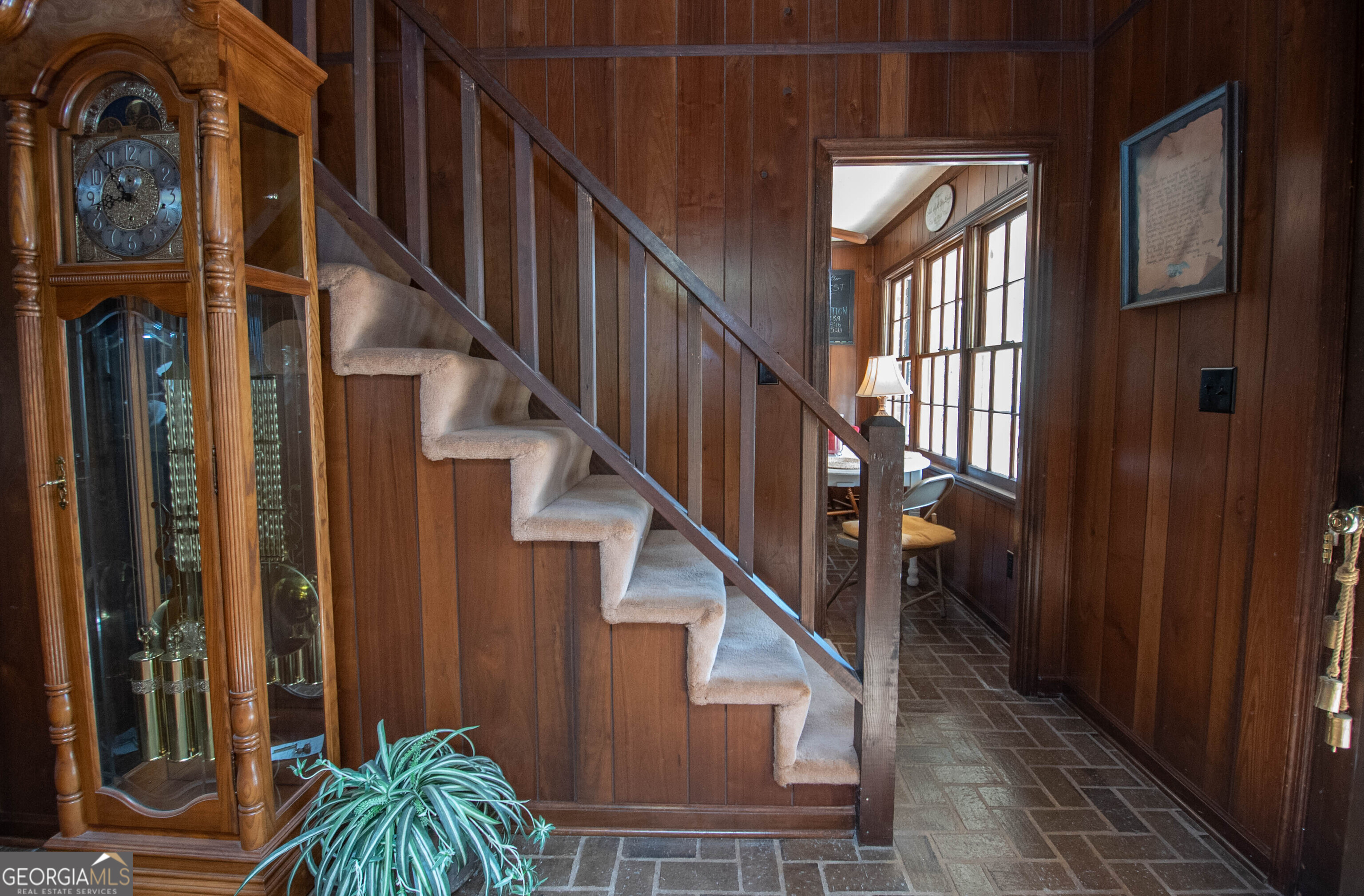 151 Evans Road Milner, GA 30257 - Photo 60 of 60 a view of staircase with lots of frames on wall and a window