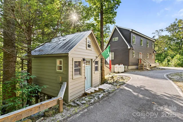 a view of a house with wooden fence next to a road