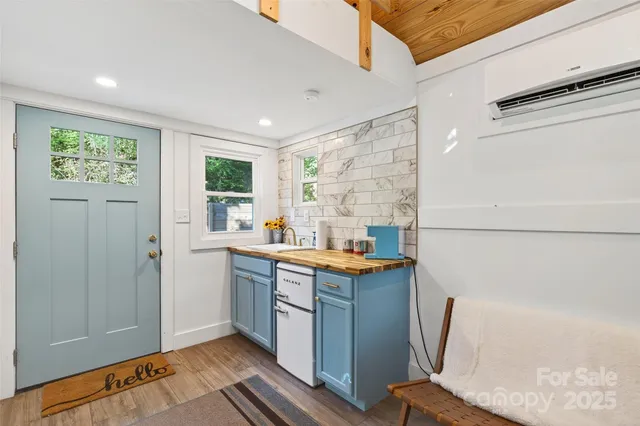a view of kitchen with stainless steel appliances granite countertop a refrigerator and a sink