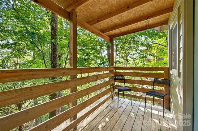 a view of two chairs in a balcony
