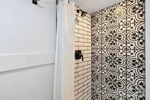 a bathroom with a shower and a shower curtain